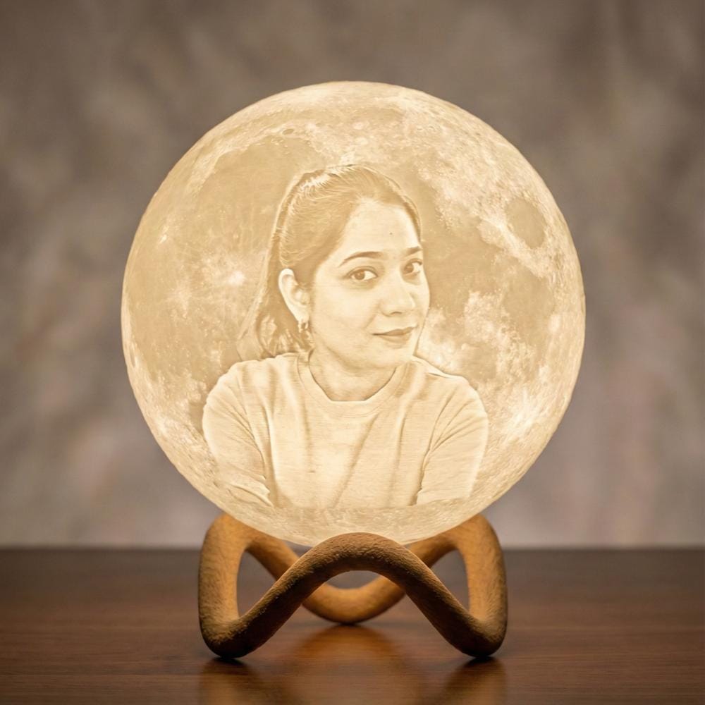 Custom photo moon lamp glowing on a wooden stand